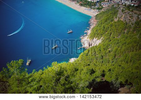 yachts float in a quiet comfortable blue lagoon among the mountains of turkey