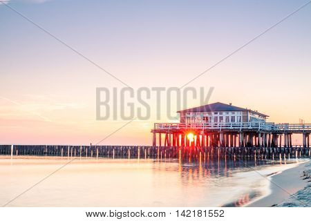 Restaurant at wooden pier on the baltic sea during sunrise. Ustronie Morskie Poland.