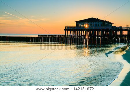 Restaurant at wooden pier on the baltic sea during sunrise. Ustronie Morskie Poland.