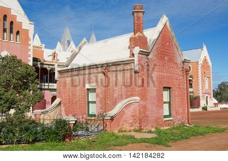 NEW NORCIA,WA,AUSTRALIA-JULY 15,2016: St. Gertrude's Ladies College rear view with red brick Spanish gothic architecture under a blue sky in the monastic town of New Norcia, Western Australia.