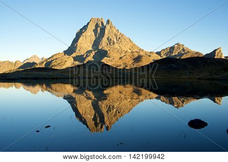 Midi Dossau Peak reflected in Miey lake. Ossau Valley, Pyrenees National Park, Pyrenees, France.