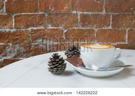 hot fresh coffee in white cup on marble table brick wall and white saucer sugar and cream cappuccino coffee mocha coffee espresso coffee latte coffee