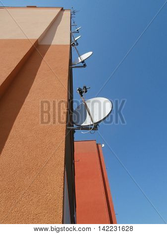 Prefab wall with satellites and blue sky