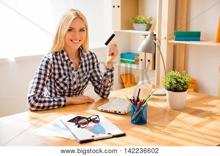 Portrait Of Happy Young Woman Holding Bank Card And Doing Internet Shopping