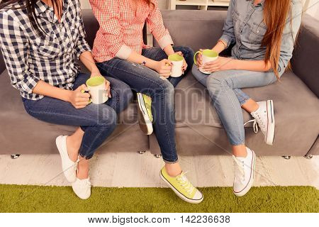 Close Up Photo Of Three Women Sitting On Couch With Cups
