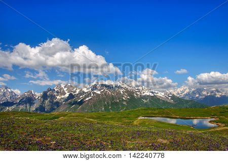 Reflection of snow-capped peaks of the main Caucasian ridge into the lake koruldi. Georgia, Svaneti