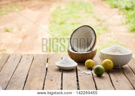 Raw material for food and dessert.Lemon and coconut powder and Sticky rice on old wooden background outdoor.Raw material Asia food.Raw material Indian food