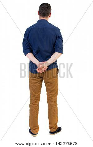 Back view of man . Standing young guy. Rear view people collection.  backside view of person.  Isolated over white background. a man in a blue shirt with the sleeves rolled up, standing with his hands