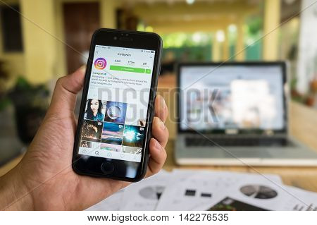 CHIANG MAI THAILAND - JULY 7 2016: A man hand holding iphone with new logo of instagram application. Instagram is largest and most popular photograph social networking.