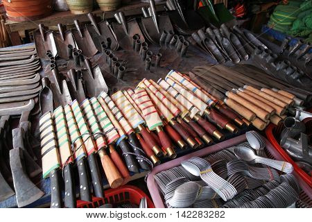 Various metal tools and implements in a market in Phomsavan Laos. Markets like this provide the local people with their everyday needs.