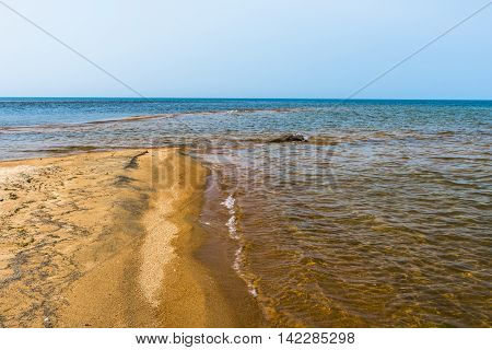 Old snag, polished by the waves of lake Baikal, lies at the mouth of the river Kika. From a distance it is very similar to the head of a crocodile.