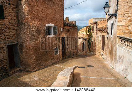 Paving stone streets in historical town part of Capdepera with its traditional stone houses Mallorca Spain
