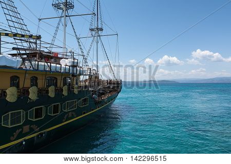 Sailing ship in the Aegean Sea on the background of mountains and hills of the Athos Peninsula Chalkidiki
