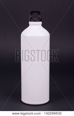 White aluminum water bottle on dark background