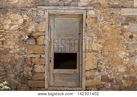 Old door in the stone walls of the village houses. Excellent background