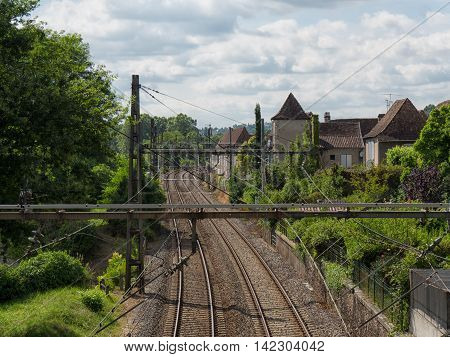 Railway track with a Orthez village in France