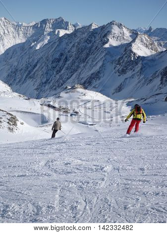 A view of a snow covered mountain with skiers a ski resort in Neustift Austria. Taken in vertical format.