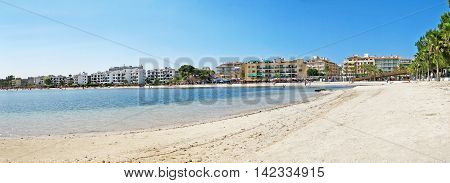 Alcudia Majorca Spain - June 26 2008: Beach panorama of Alcudia with hotels promenade and beach with water of mediterranean sea in front