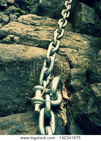 Steel Bolt Anchor Eye In Hard Basalt Rock. End Of Steel Chain