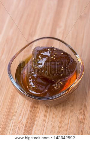 Homemade fig jam in a glass bowl on wooden background