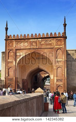 AGRA INDIA - JANUARY 28: A crowd of tourists visit Red Fort Agra on January 28 2014 in Agra Uttar Pradesh India. The fort is the old Mughal Empire capital and a UNESCO World Heritage Site.