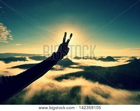 Man Hand Make Victory To Sun. Misty Daybreak In Mountains