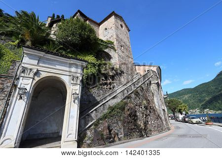 MORCOTE, SWITZERLAND - MAY 23, 2016: Village of Morcote facing Lake Lugano on May 23, 2016 in Morcote, Switzerland. It is a landmark resort at Lake Lugano.