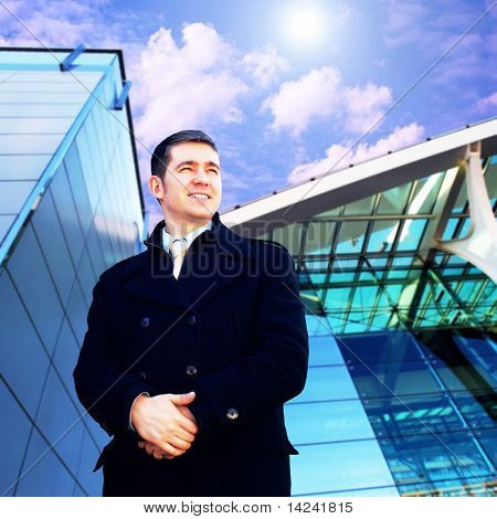 Homme d'affaires de bonheur sur le fond d'architecture d'entreprise
