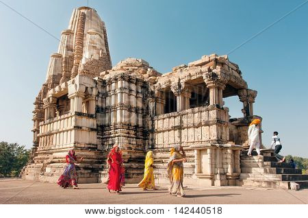 KHAJURAHO, INDIA - DEC 24, 2015: Women in indian sari dresses watching hindu temples on December 24, 2015 in Madhya Pradesh. UNESCO World Heritage Site Khajuraho Monuments built between 950 and 1150.