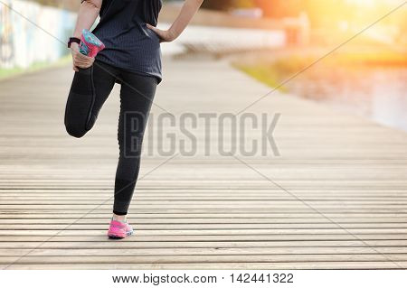 Woman stretching legs before workout and exercise. Marathon