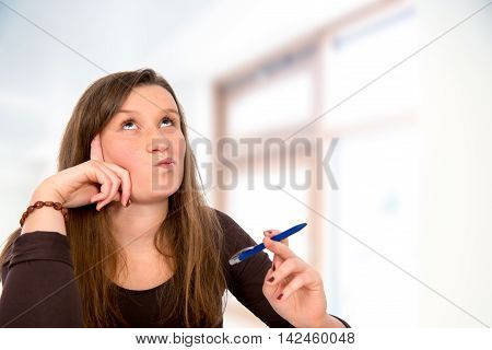young woman with pen is learning and reflecting