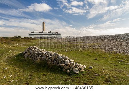 Pile Of Stones, Power Station In Distance