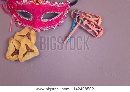 Traditional hamantaschen cookies grogger and carnival mask