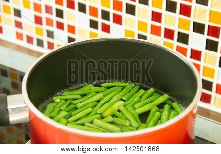 Lentils Pieces In Boiling Water In Red Pot.