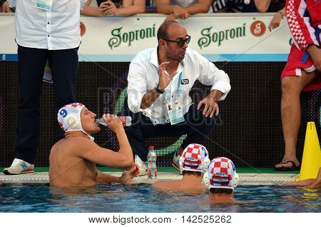 Budapest Hungary - Jul 15 2014. Ivica Tucak (head coach) talking to the croatian team. The Waterpolo European Championship was held in Alfred Hajos Swimming Centre in 2014.