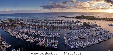 Panoramic view of the Ala Wai Boat Harbor and Magic Island Lagoon in Honolulu, Hawaii at sunset.