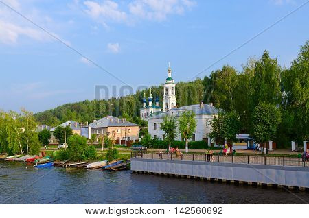 PLES RUSSIA - JULY 20 2016: Unidentified people walk on promenade near river quay of small provincial town of Ples Russia