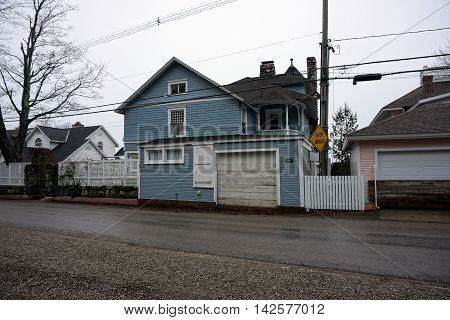WEQUETONSING, MICHIGAN / UNITED STATES - DECEMBER 22, 2015: A large blue mansion on Beach Drive in Wequetonsing.