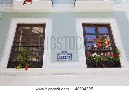 A wall of a house with balcony and flowerpots Granada Spain