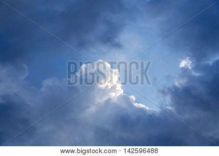 Deep blue sky, and dramatic clouds with sun light.