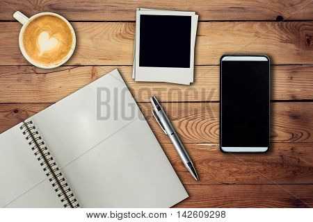 Mobile Phone, Notebook Pen, Photo Frame And Coffee Cup On Office Wooden Table With Copy Space.