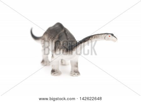 grey brachiosaurus toy on a white background