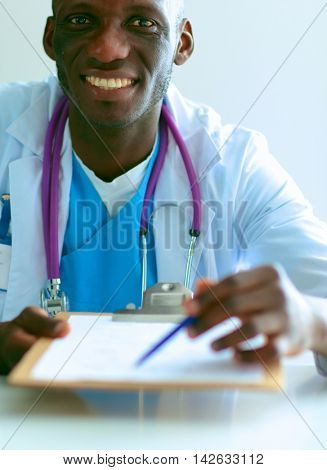 Male doctor sitting at his desk