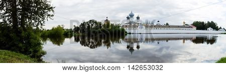 Panorama of Tikhvin assumption male monastery and Tikhvin icon of the mother of God. The Orthodox Church of Russia. The temple on the banks of the Tikhvinka river in Tikhvin.