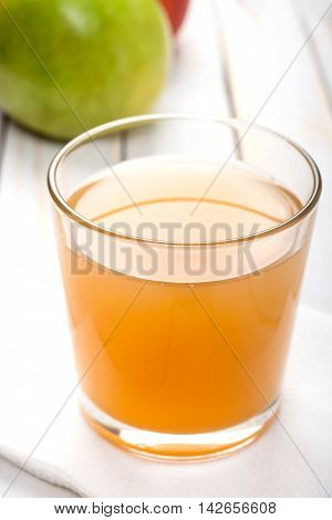 Glass of apple juice vertical closeup shot