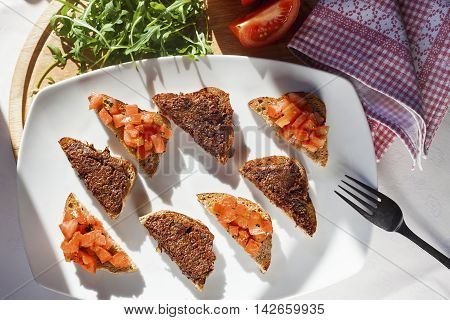 Brochette with tomato and olives, top view