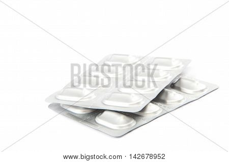 Pills in blister packs isolated on white background.
