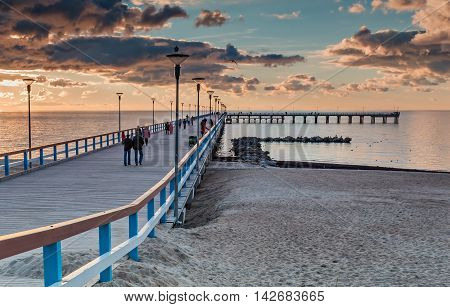 Colorful sunset at a famous marine pier in the Baltic resort city of Palanga, Lithuania, Europe