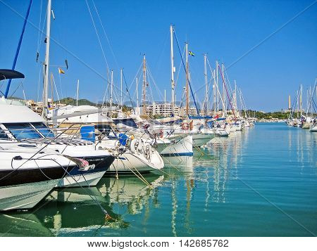 Alcudia Majorca Spain - June 26 2008: Habor of Alcudia with boats in row - view from promenade