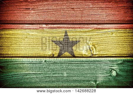 Flag of Ghana painted on old grungy wooden background: 3d illustration